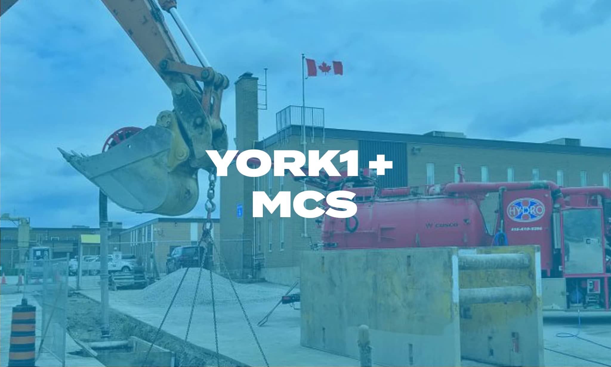Hydrovac truck and excavator on a job site. Photo with blue overlay, YORK1 + MCS in white text.